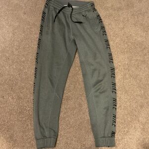 Stylish Dri-fit heather gray sweatpants. Nike branding along the sides.